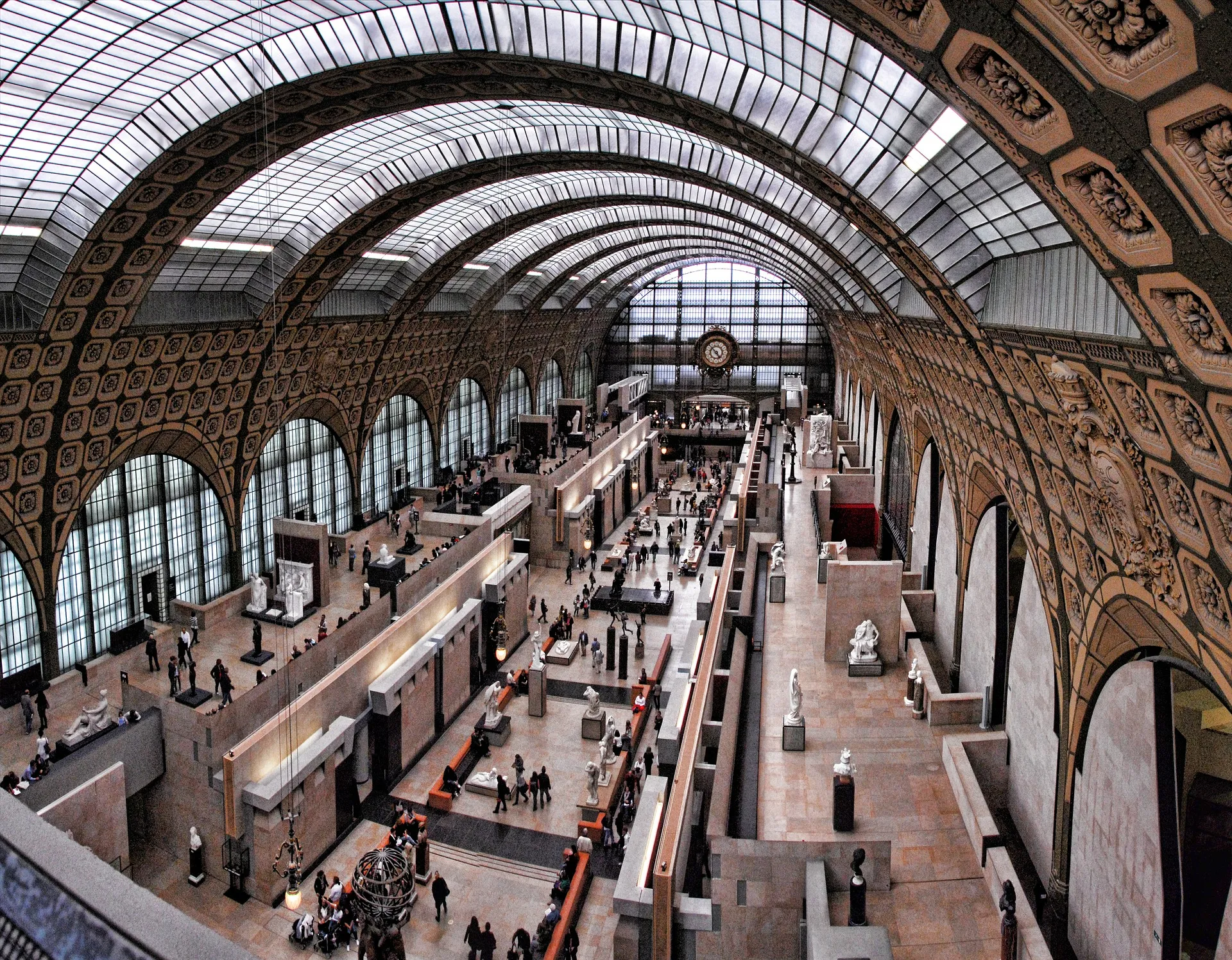 Sunlit iron‑and‑glass roof over the museum’s central nave